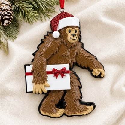 Personalized Yeti big foot christmas ornament laid on a soft white knit blanket