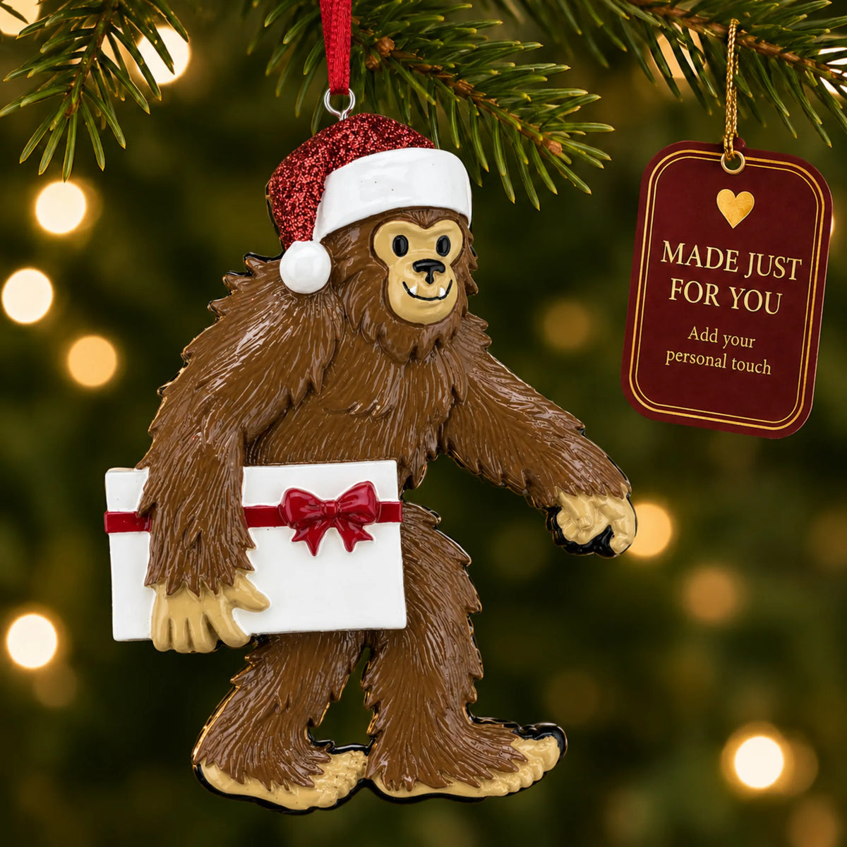 Yeti big foot christmas ornament hanging on a lit Christmas tree with a Made Just For You gift tag