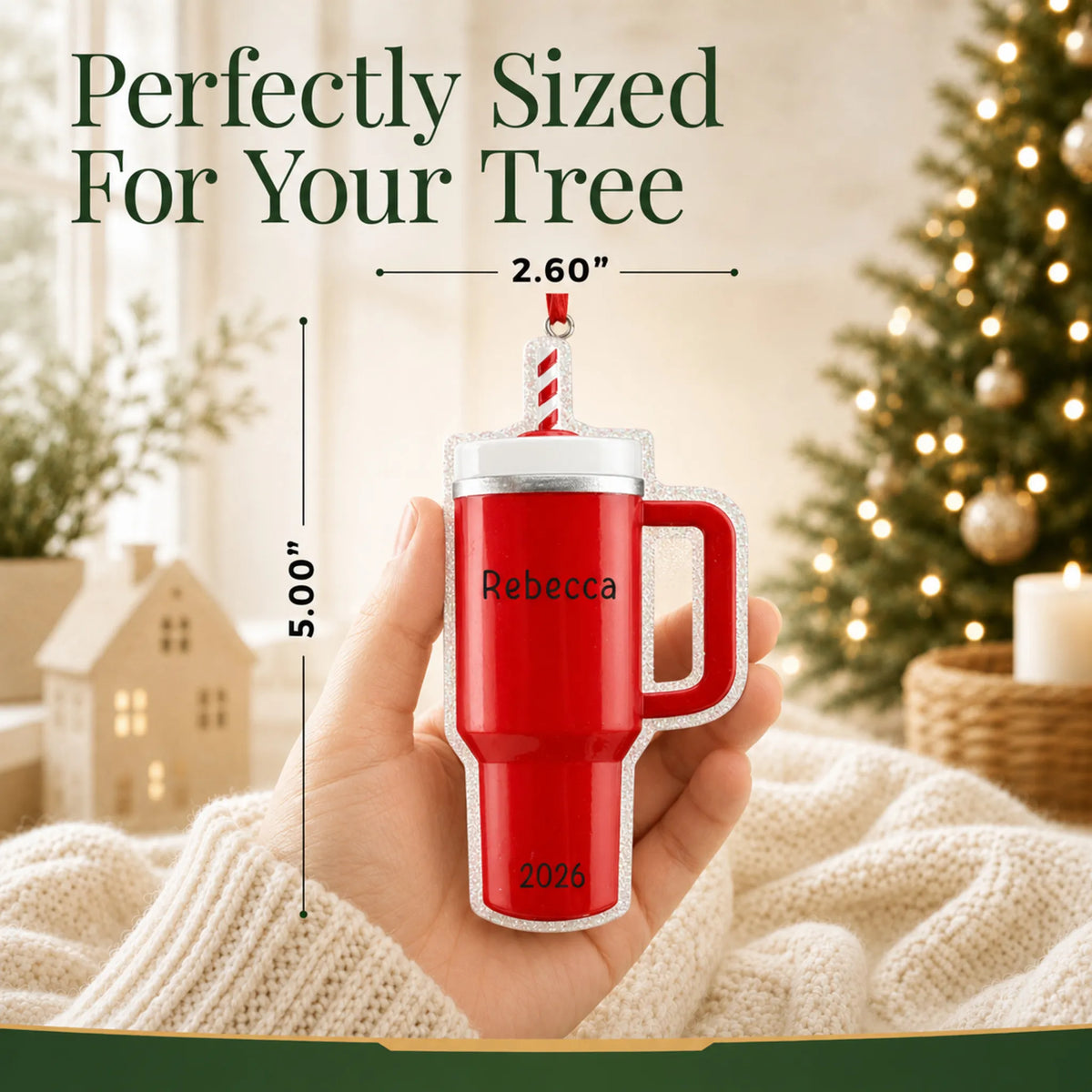 Size guide: the personalized Red Tumbler Stanley Cup christmas ornament shown in hand next to a Christmas tree