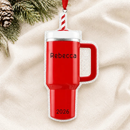 Personalized Red Tumbler Stanley Cup christmas ornament laid on a soft white knit blanket