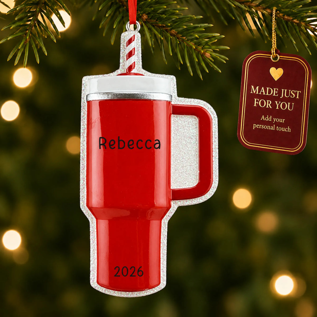 Red Tumbler Stanley Cup christmas ornament hanging on a lit Christmas tree with a Made Just For You gift tag
