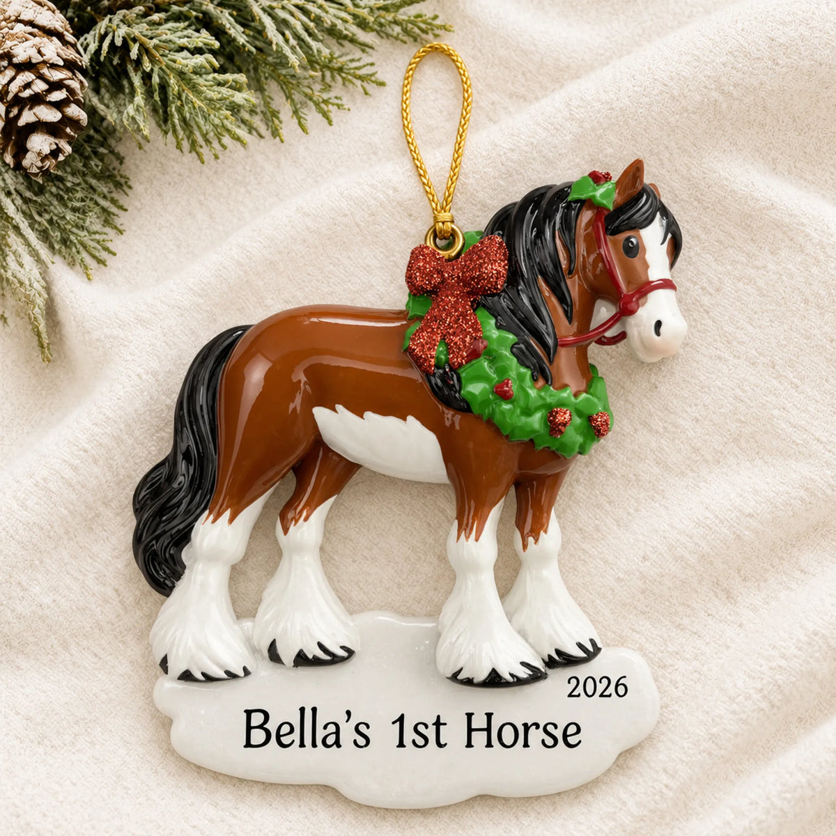 Personalized clydesdale horse christmas ornament laid on a soft white knit blanket