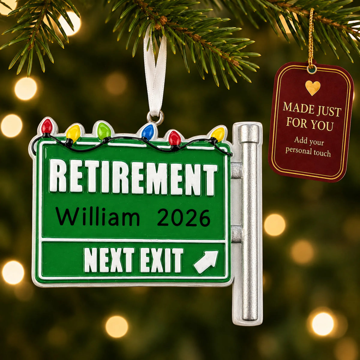 Retirement christmas ornament hanging on a lit Christmas tree with a Made Just For You gift tag