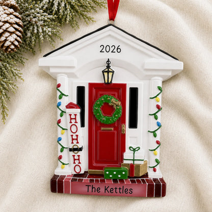 Personalized Holiday Front Door christmas ornament laid on a soft white knit blanket