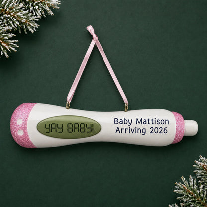 Personalized Pregnancy Test Baby Girl christmas ornament on a dark green pine background