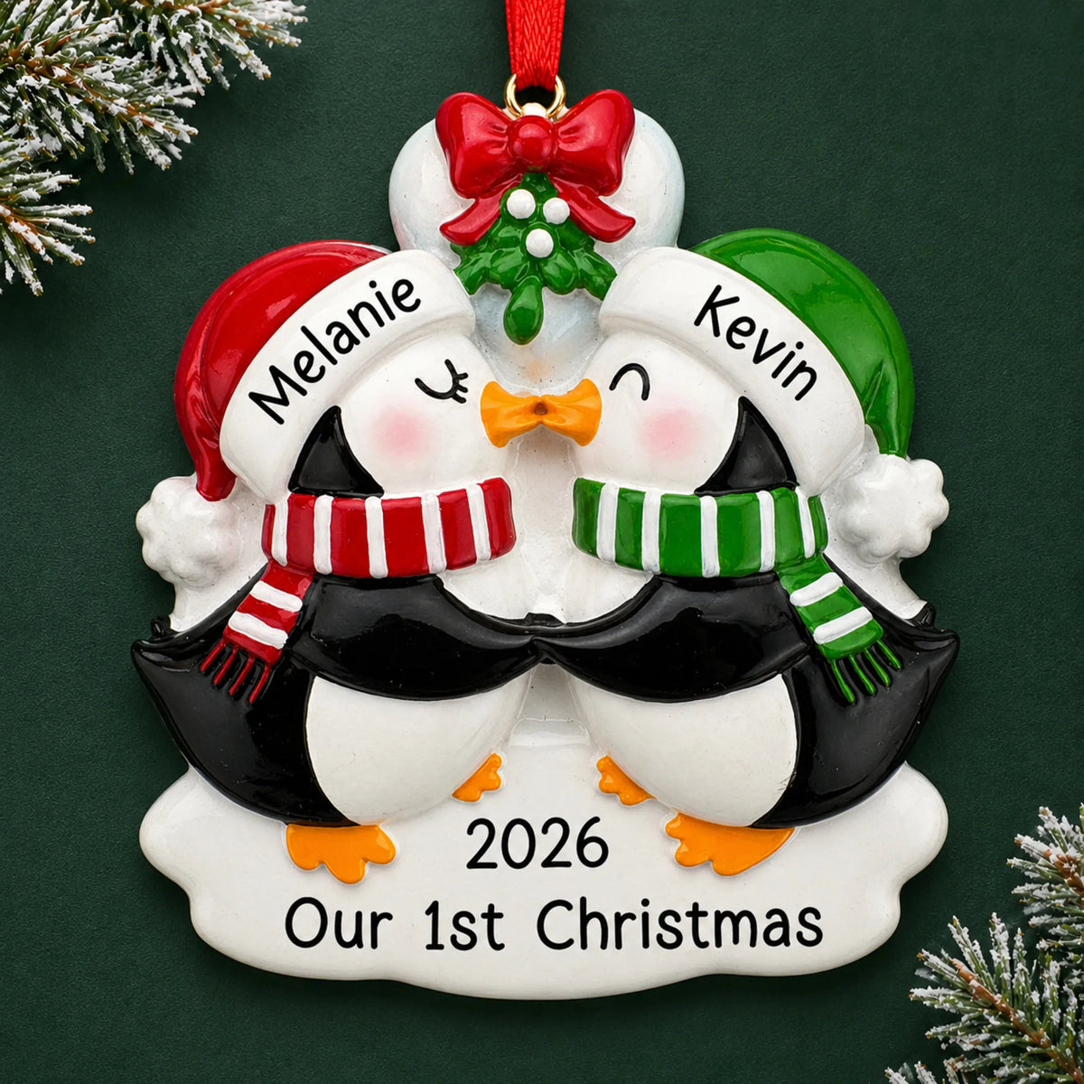 Personalized penguin mistletoe kisses couple christmas ornament on a dark green pine background