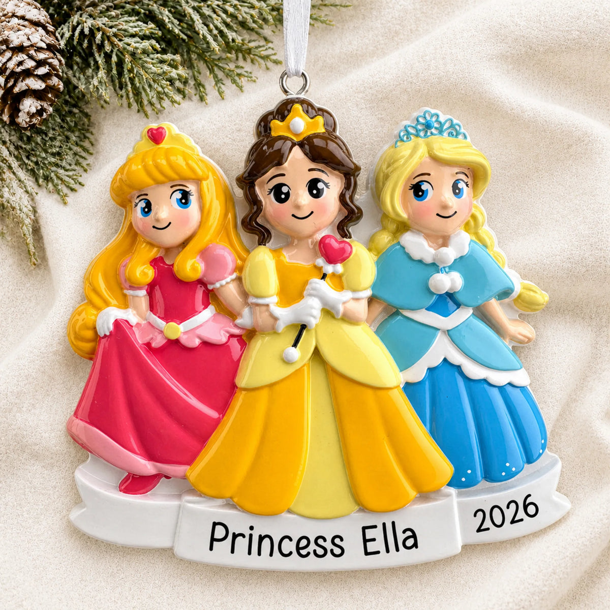 Personalized Princesses In Dresses christmas ornament laid on a soft white knit blanket