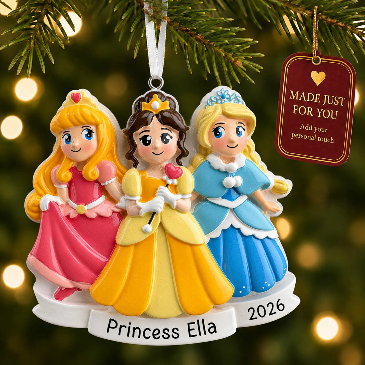 Princesses in dresses christmas ornament hanging on a lit Christmas tree with a Made Just For You gift tag