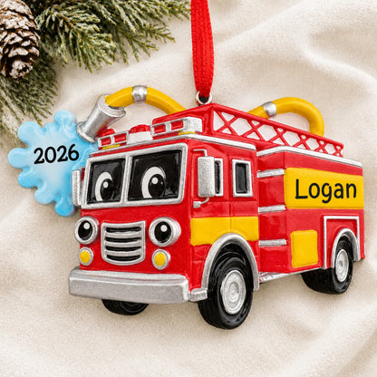 Personalized firetruck with hose christmas ornament laid on a soft white knit blanket