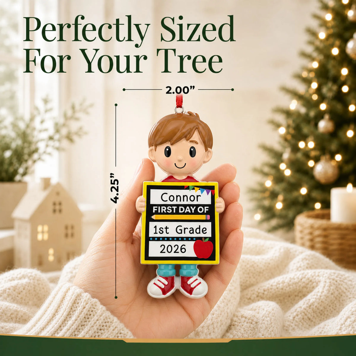 Personalized first day of school boy Christmas ornament held in hand to show its size on the tree
