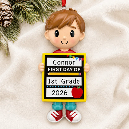 Personalized first day of school boy Christmas ornament shown on a soft white blanket