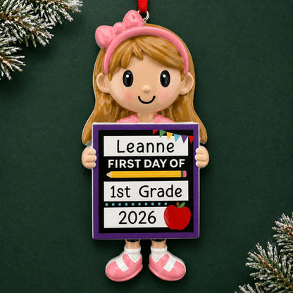 Personalized first day of school girl Christmas ornament with name and year, shown on a green holiday background