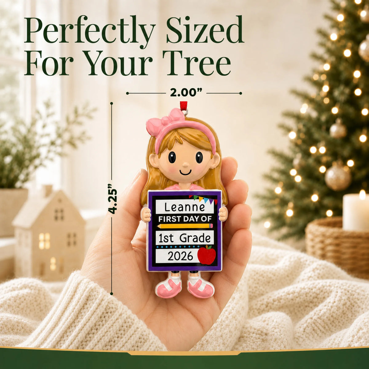 Personalized first day of school girl Christmas ornament held in hand to show its size on the tree