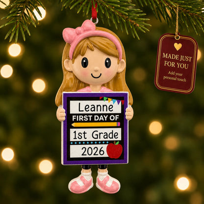 Personalized first day of school girl Christmas ornament hanging among tree lights with a Made Just For You tag