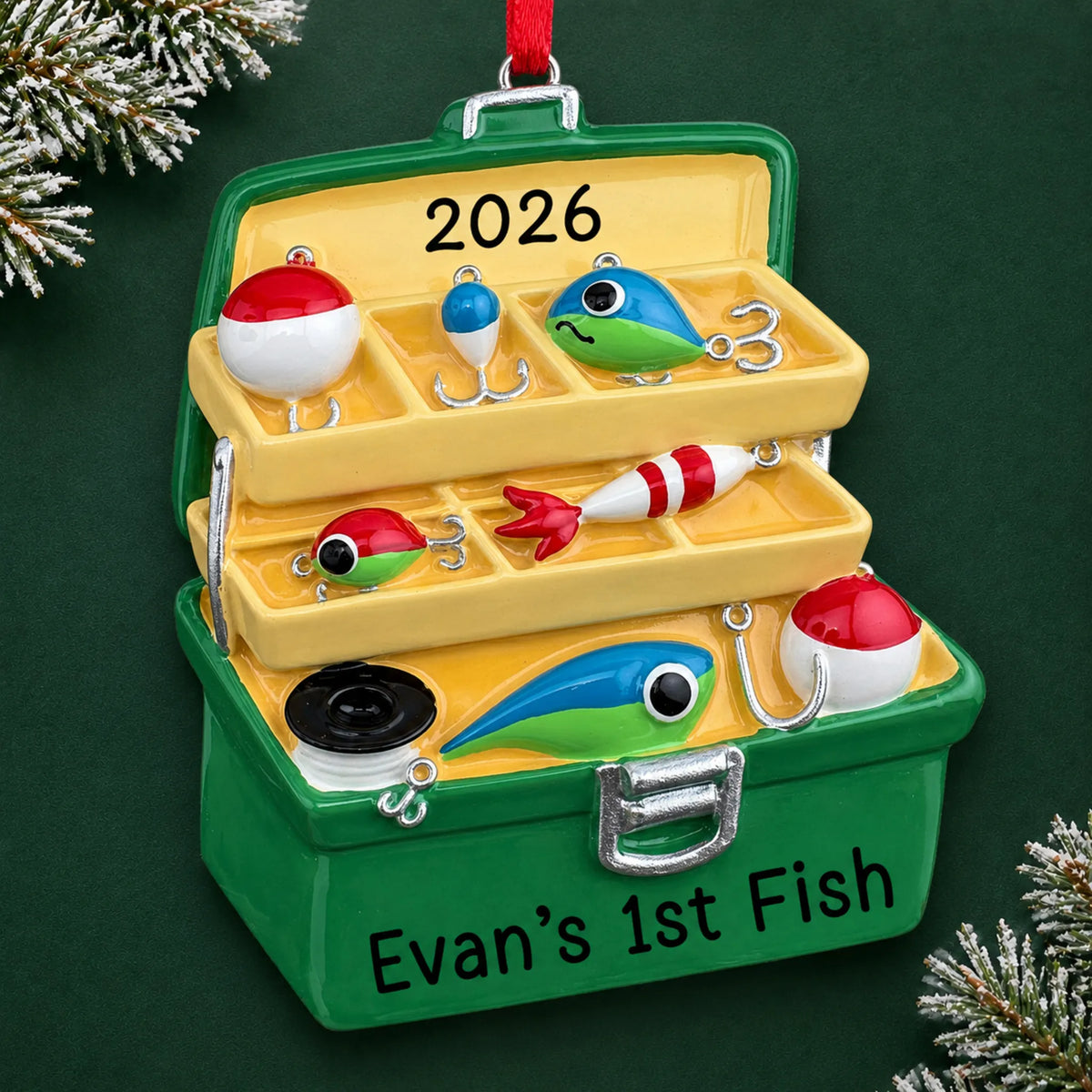 Personalized green fishing tackle box christmas ornament on a dark green pine background
