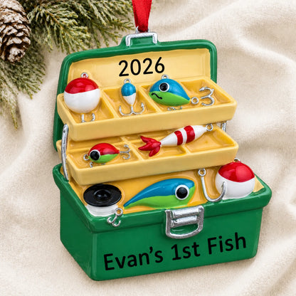 Personalized green fishing tackle box christmas ornament laid on a soft white knit blanket