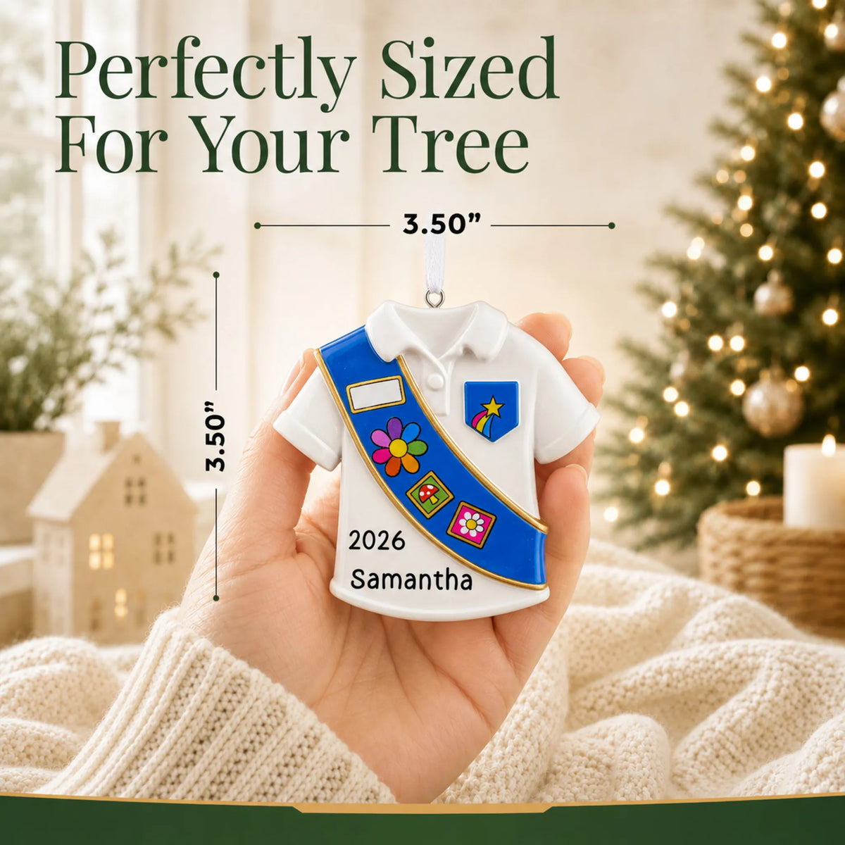 Size guide: the personalized Girl Scout blue sash christmas ornament is 3.50 in wide by 3.50 in tall, shown in hand