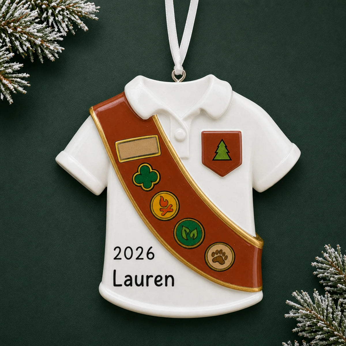 Personalized Girl Scout brown sash christmas ornament on a dark green pine background