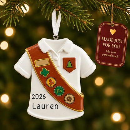 Girl Scout brown sash christmas ornament hanging on a lit Christmas tree with a Made Just For You gift tag