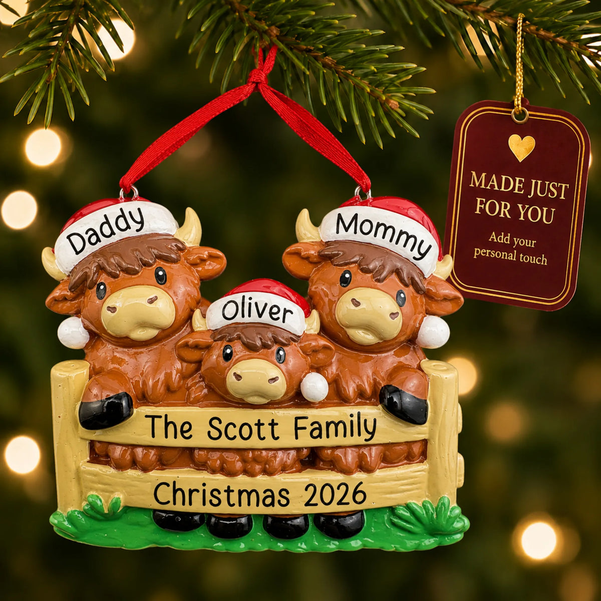 Highland cow family of 3 christmas ornament hanging on a lit Christmas tree with a Made Just For You gift tag