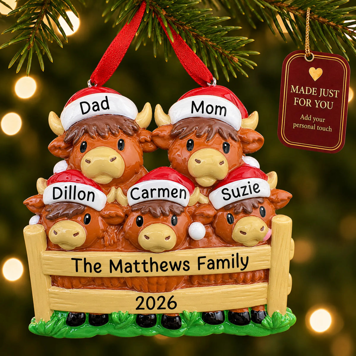 Highland cow family of 5 christmas ornament hanging on a lit Christmas tree with a Made Just For You gift tag