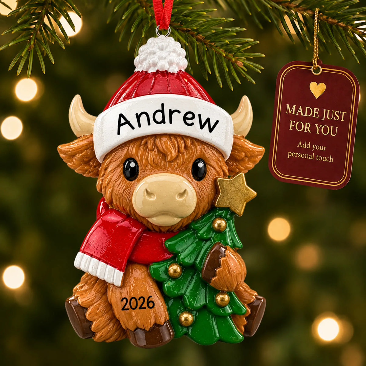 Highland baby cow christmas ornament hanging on a lit Christmas tree with a Made Just For You gift tag