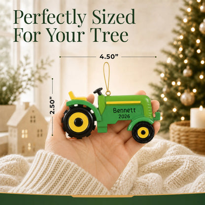 Size guide: the personalized farm tractor christmas ornament is 4.50 in wide by 2.50 in tall, shown in hand