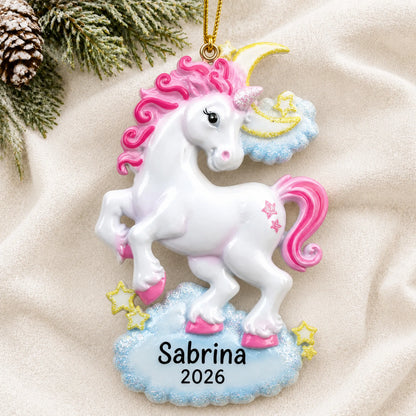 Personalized unicorn sparkles christmas ornament laid on a soft white knit blanket