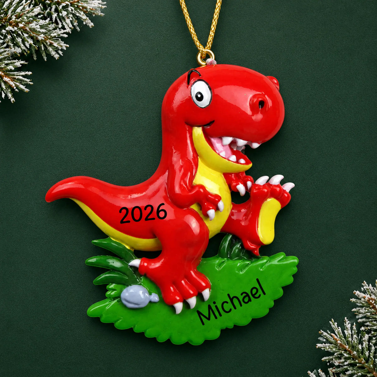 Personalized red t-rex christmas ornament on a dark green pine background
