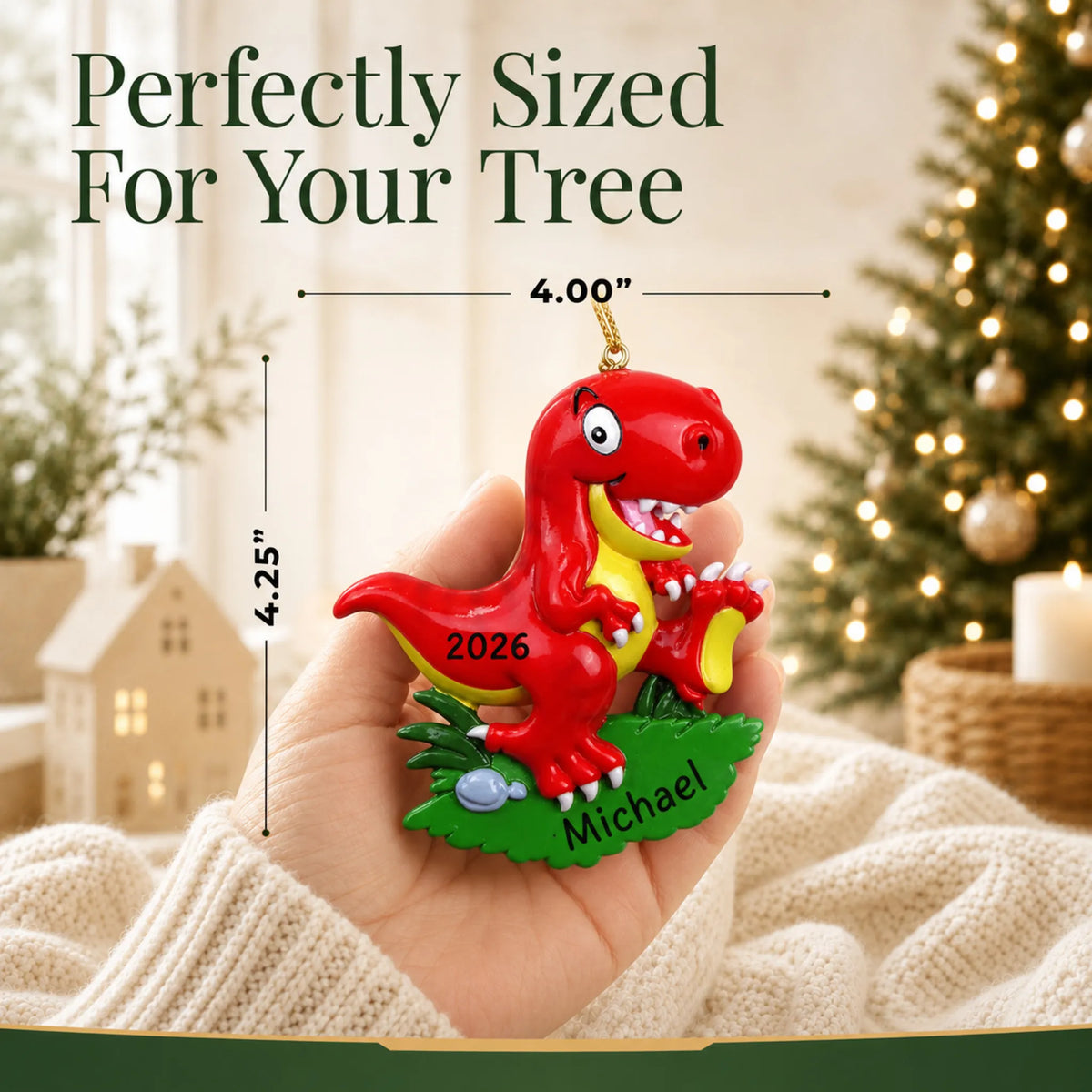 Size guide: the personalized red t-rex christmas ornament is 4.25 in wide by 4.00 in tall, shown in hand