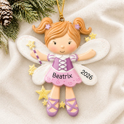 Personalized fairy christmas ornament laid on a soft white knit blanket