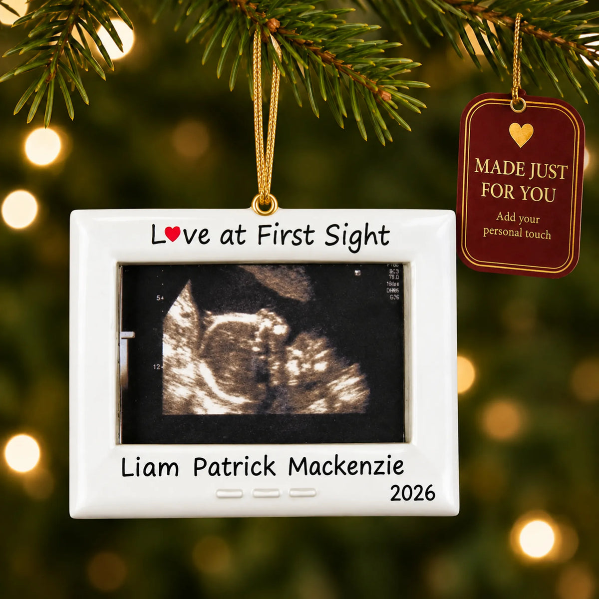 New Baby Ultrasound Frame christmas ornament hanging on a lit Christmas tree with a Made Just For You gift tag