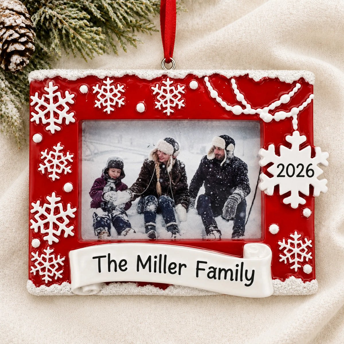 Personalized Red Photo Frame christmas ornament laid on a soft white knit blanket
