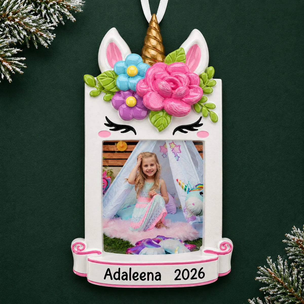 Personalized unicorn photo frame christmas ornament on a dark green pine background