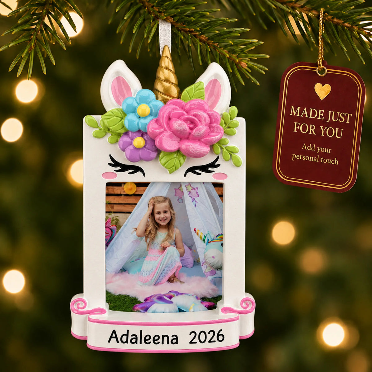 Unicorn photo frame christmas ornament hanging on a lit Christmas tree with a Made Just For You gift tag