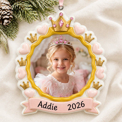 Personalized princess crown photo frame christmas ornament laid on a soft white knit blanket