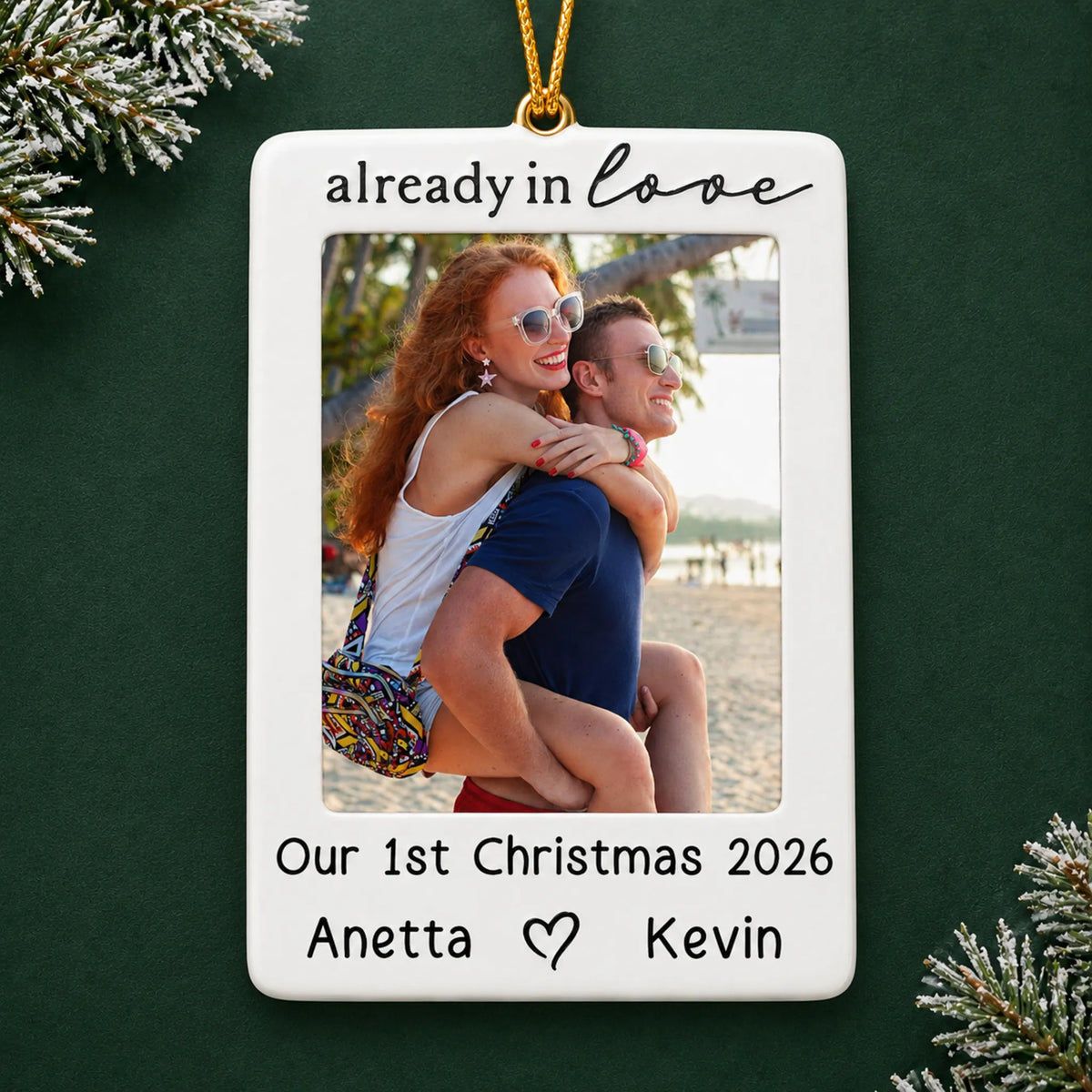 Personalized couple photo frame christmas ornament on a dark green pine background