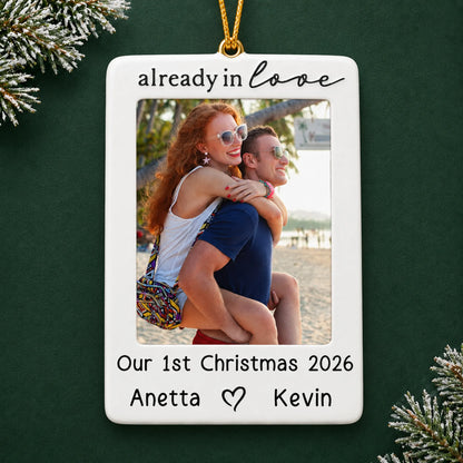 Personalized couple photo frame christmas ornament on a dark green pine background