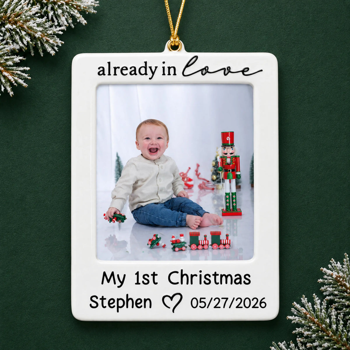 Personalized already in love baby photo frame christmas ornament on a dark green pine background