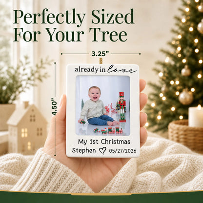 Size guide: the personalized already in love baby photo frame christmas ornament shown in hand next to a Christmas tree