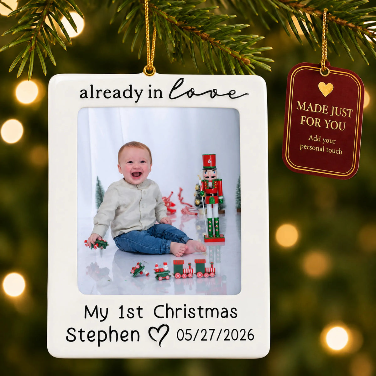Already in love baby photo frame christmas ornament hanging on a lit Christmas tree with a Made Just For You gift tag