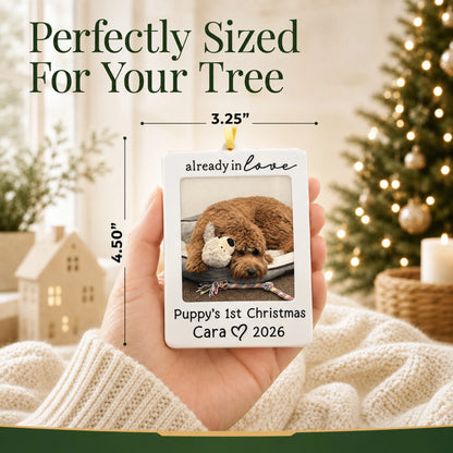 Size guide: the personalized Already in Love Puppy Photo Frame christmas ornament is 3.25 in wide by 4.50 in tall, shown in hand