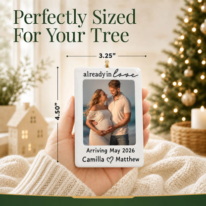Size guide: the personalized Expecting Couple Photo Frame christmas ornament is 3.25 in wide by 4.50 in tall, shown in hand