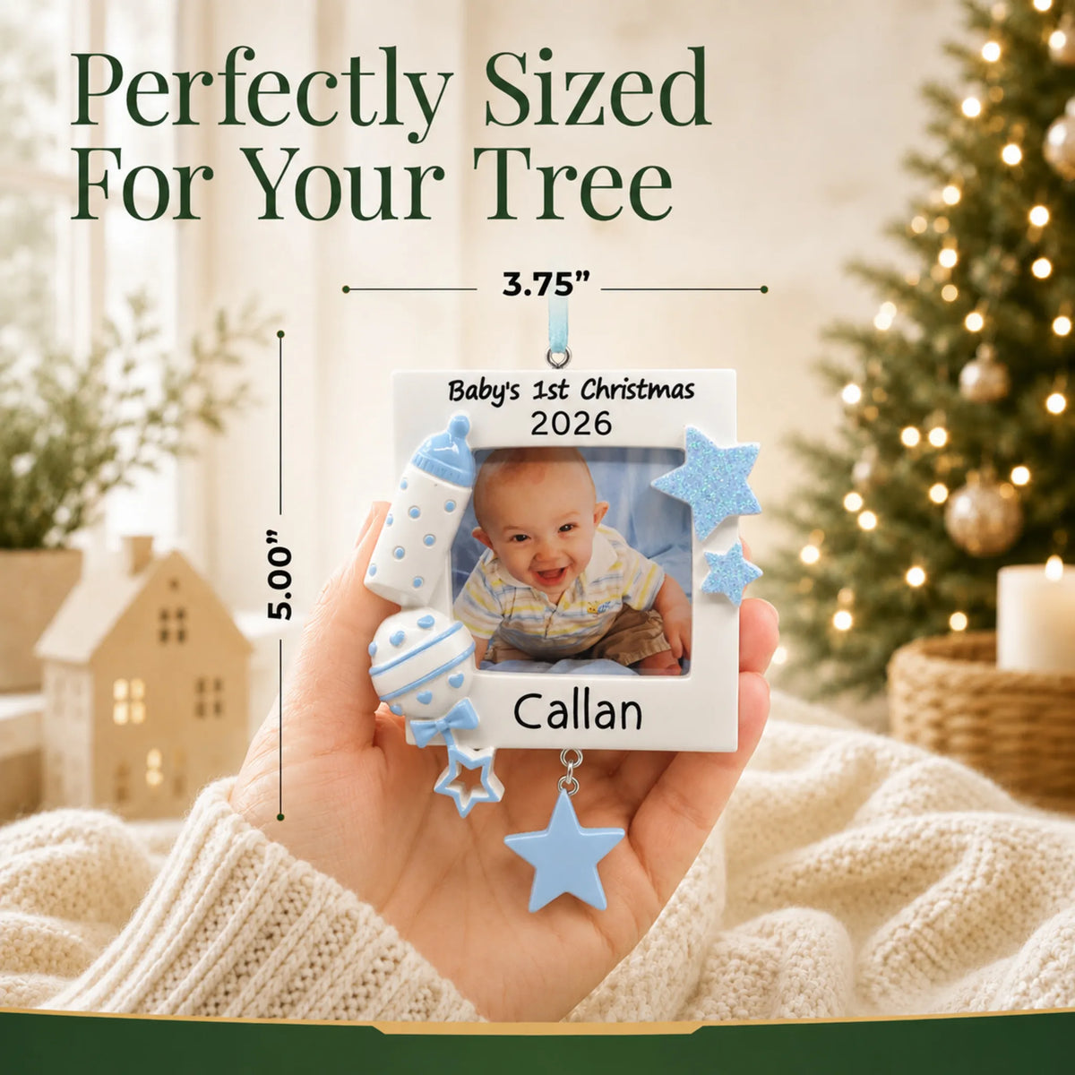 Size guide: the personalized blue baby's first picture frame christmas ornament shown in hand next to a Christmas tree