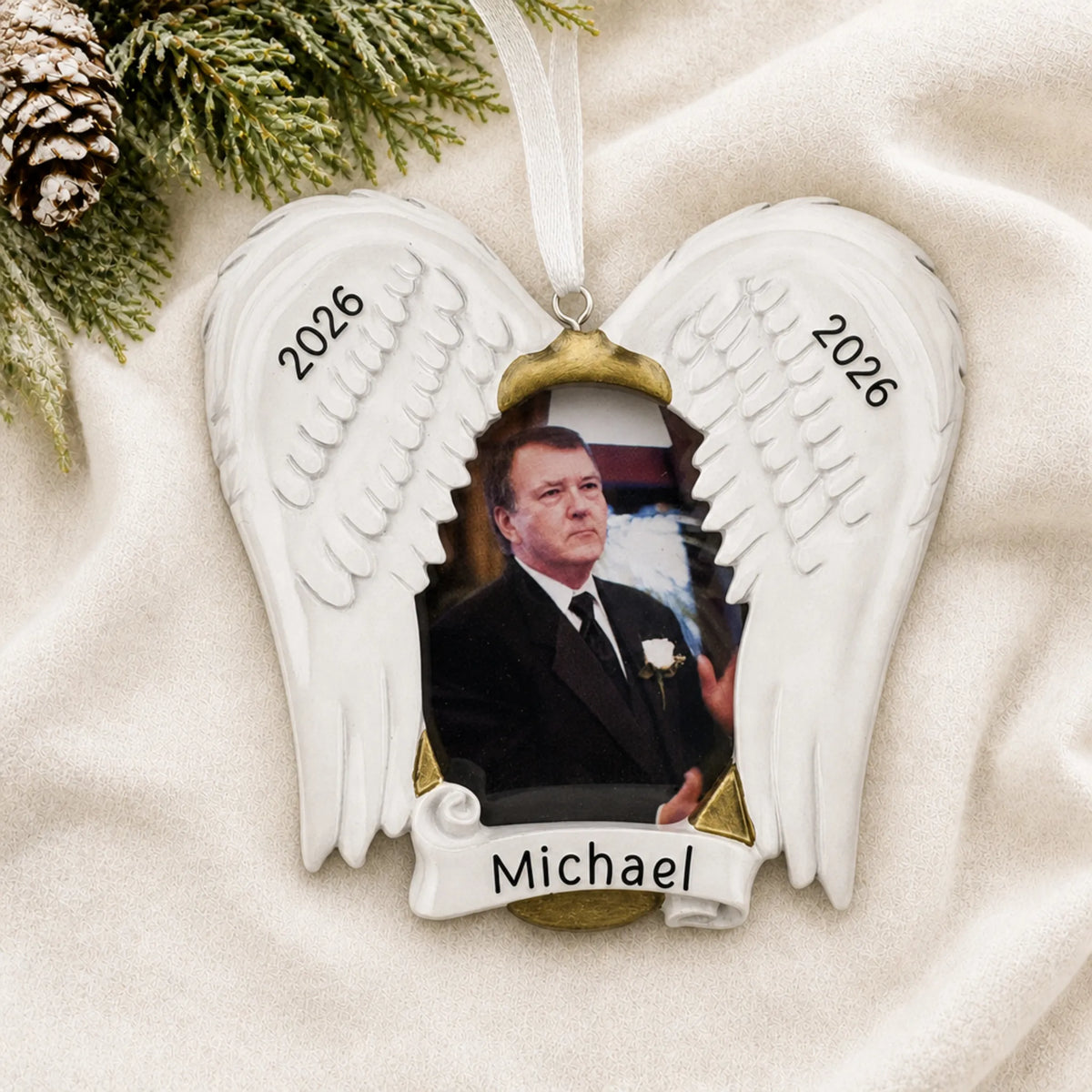 Personalized In Loving Memory Photo Frame christmas ornament laid on a soft white knit blanket