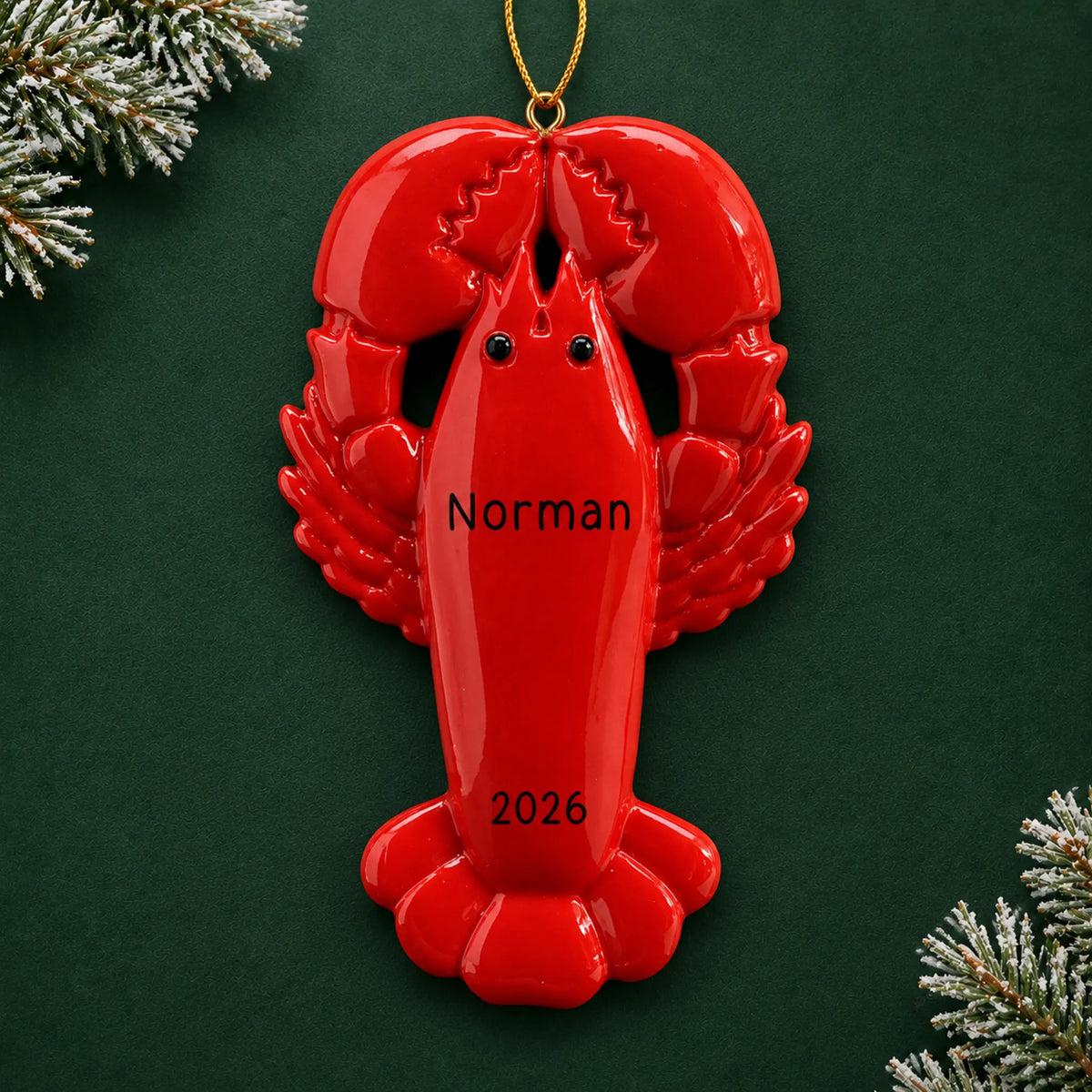 Personalized lobster christmas ornament on a dark green pine background