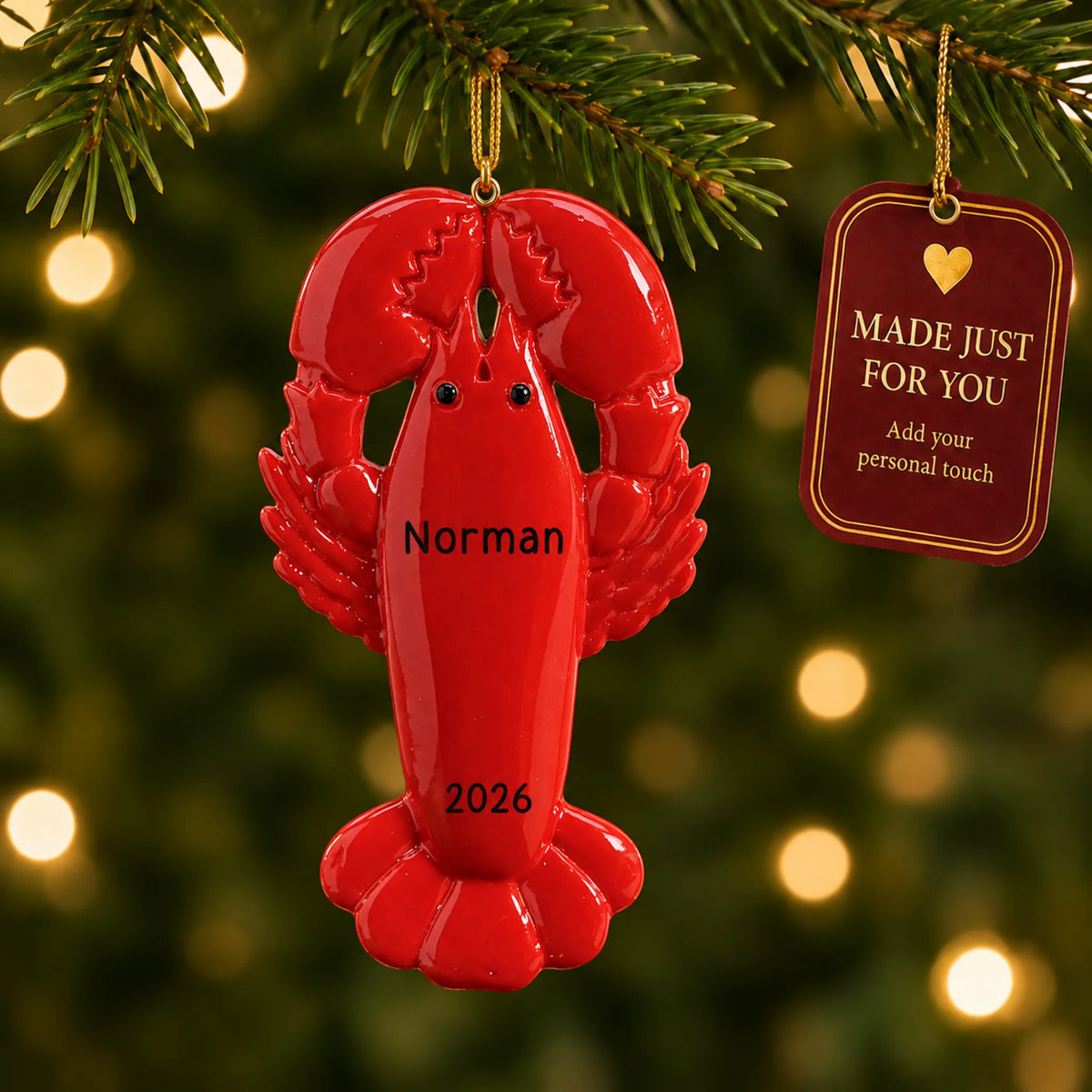 Lobster christmas ornament hanging on a lit Christmas tree with a Made Just For You gift tag