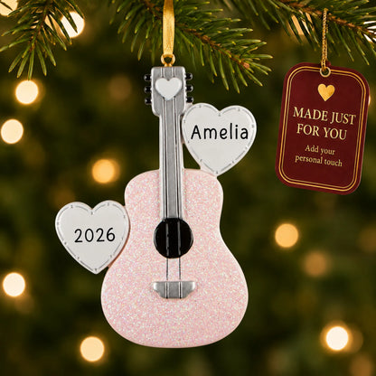 Pink guitar christmas ornament hanging on a lit Christmas tree with a Made Just For You gift tag