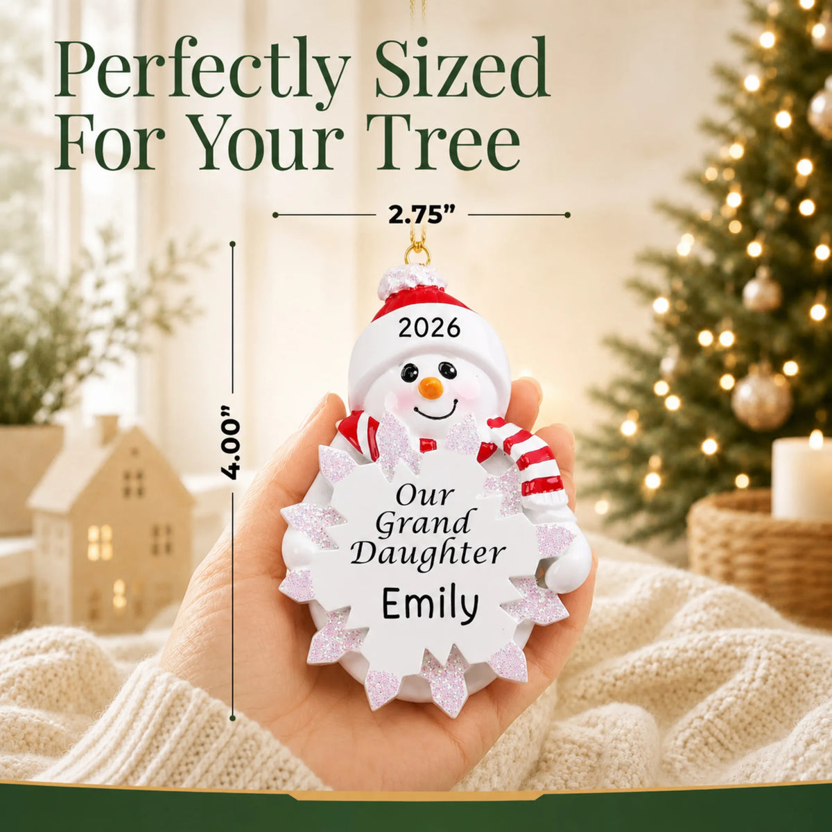 Size guide: the personalized granddaughter snowman christmas ornament is 2.75 in wide by 4.00 in tall, shown in hand