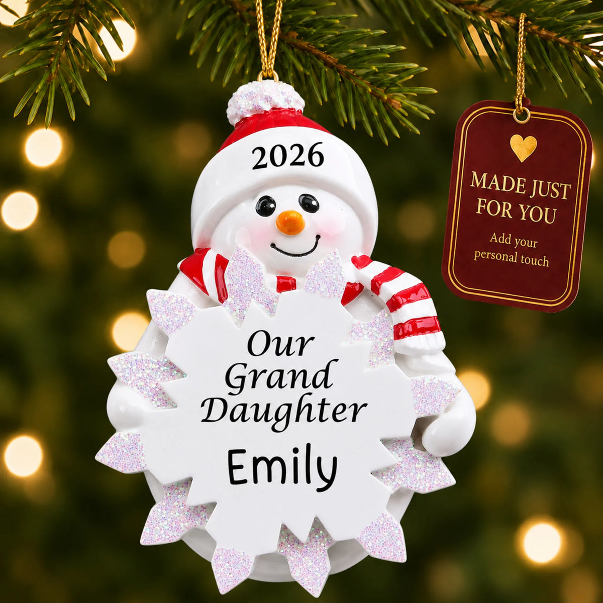Granddaughter snowman christmas ornament hanging on a lit Christmas tree with a Made Just For You gift tag